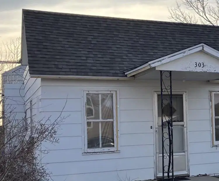 View of repaired roof on white house