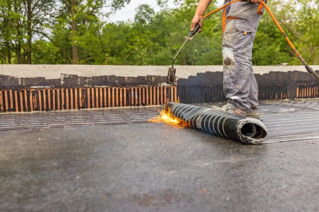 Bituminous membrane waterproofing system details and installation on flat rooftop.