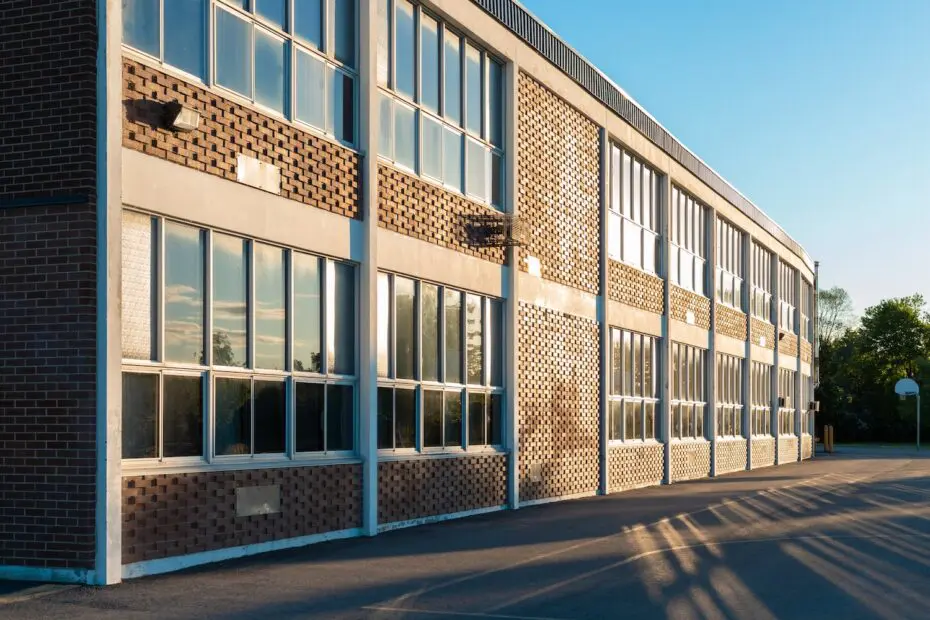 School building and schoolyard in the evening