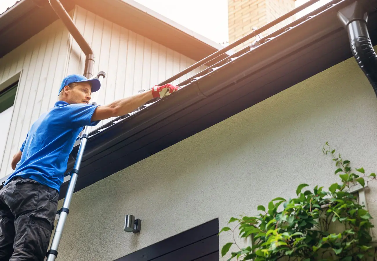 Man installing a new gutter on a home