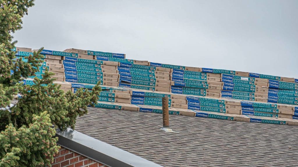 Commercial building roof with stacks of shingles on top