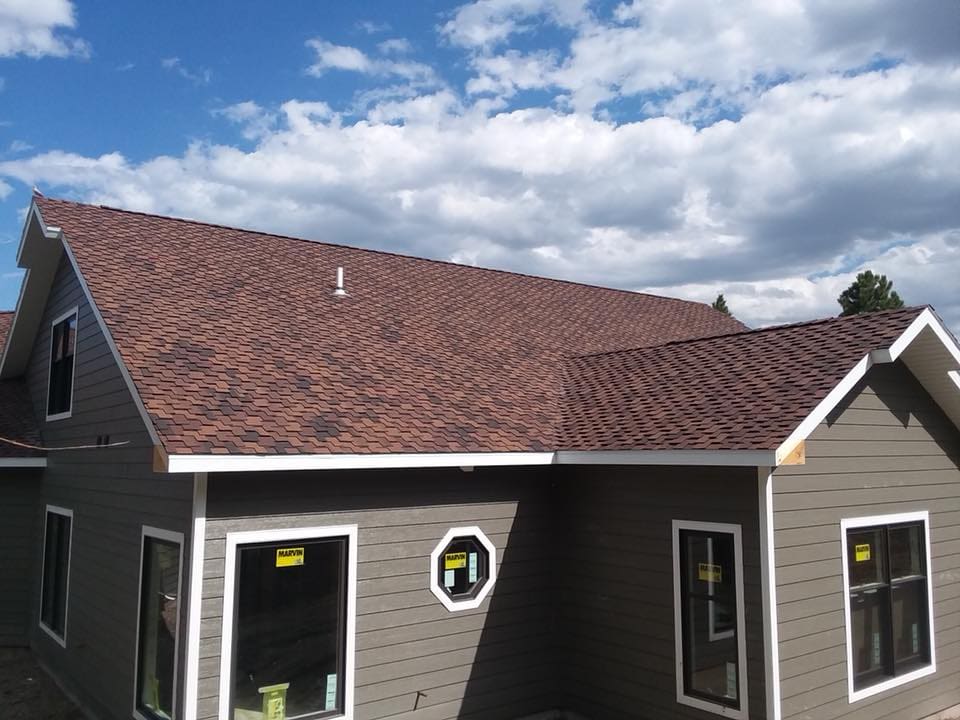 Dark taupe residential home with brown roof