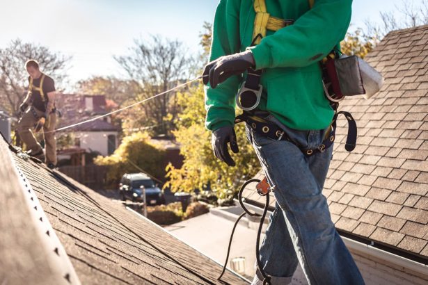 Roof Repair Crew on Roof of Home in Residential Neighborhood Roof Repair Crew on Roof of Home in Residential Neighborhood